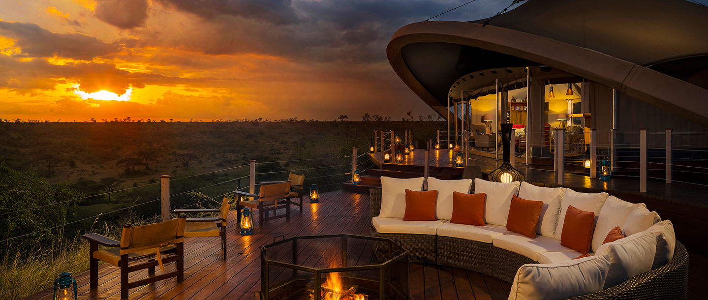 Scenic lodge deck at dusk overlooking tranquil forest in Maasai Mara