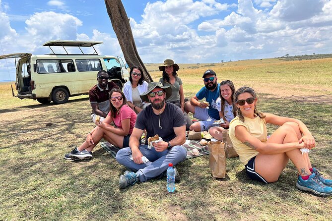 Group of individuals seated under a tree near a parked vehicle in Serengeti National
Park