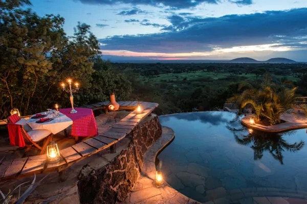 A serene deck with a fire pit and comfortable lounge chairs, providing a breathtaking view of the sunset.