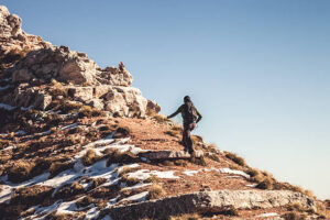 Woman in mountain climbing rocks during a beautiful day.