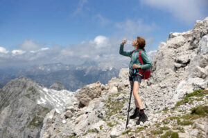 Killing Thirst and Hydrating 'Symptoms' with a bottle of fresh Water for a Female Mid Adult Hiker in High Mountains 
