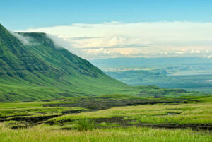 View into the Rift Valley from the slopes of the mountain Ol Doinyo Lengai. This is an active vulcanoe in Northern Tanzania, between the Rift Valley escarpment (seen on the left) and Lake Natron (very right), close to the border beween Tanzania and Kenya. There is permanent vulcanic activity at the crater plateau. The Masai-tribe believes that this mountain is the home of their god "ngai".