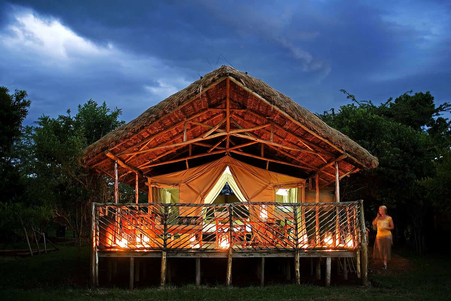 A tent with a fire lit on the deck at Karen Blixen Camp.