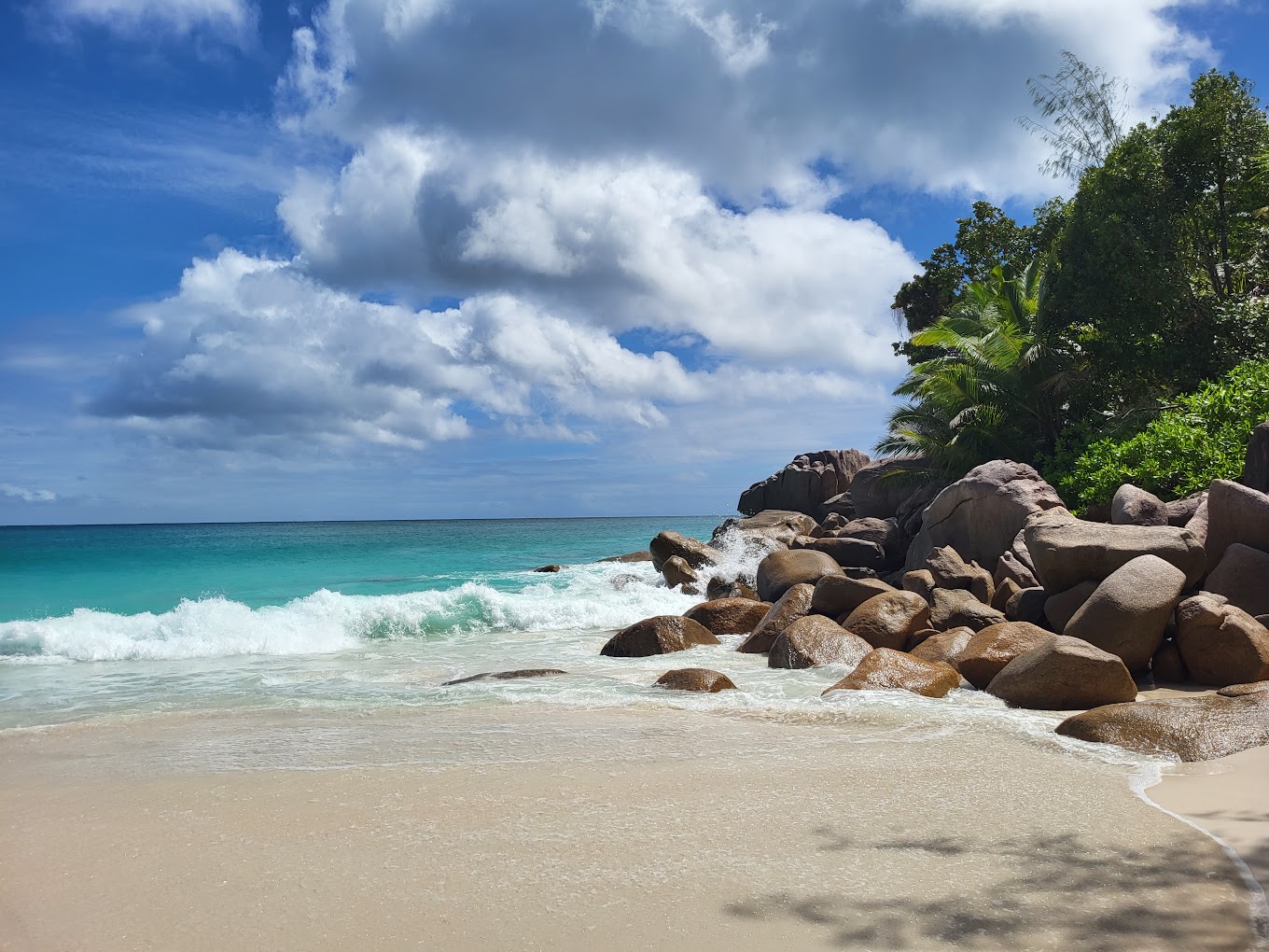 Beautiful Anse Georgette Beach in Seychelles showcasing sandy coastline, rocks, and water.