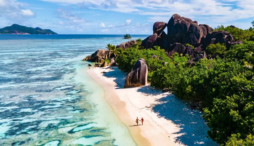 An idyllic scene from the Seychelles, featuring pristine waters and vibrant greenery typical of this tropical paradise.