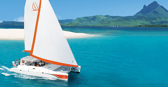Catamaran sailling under clear skies