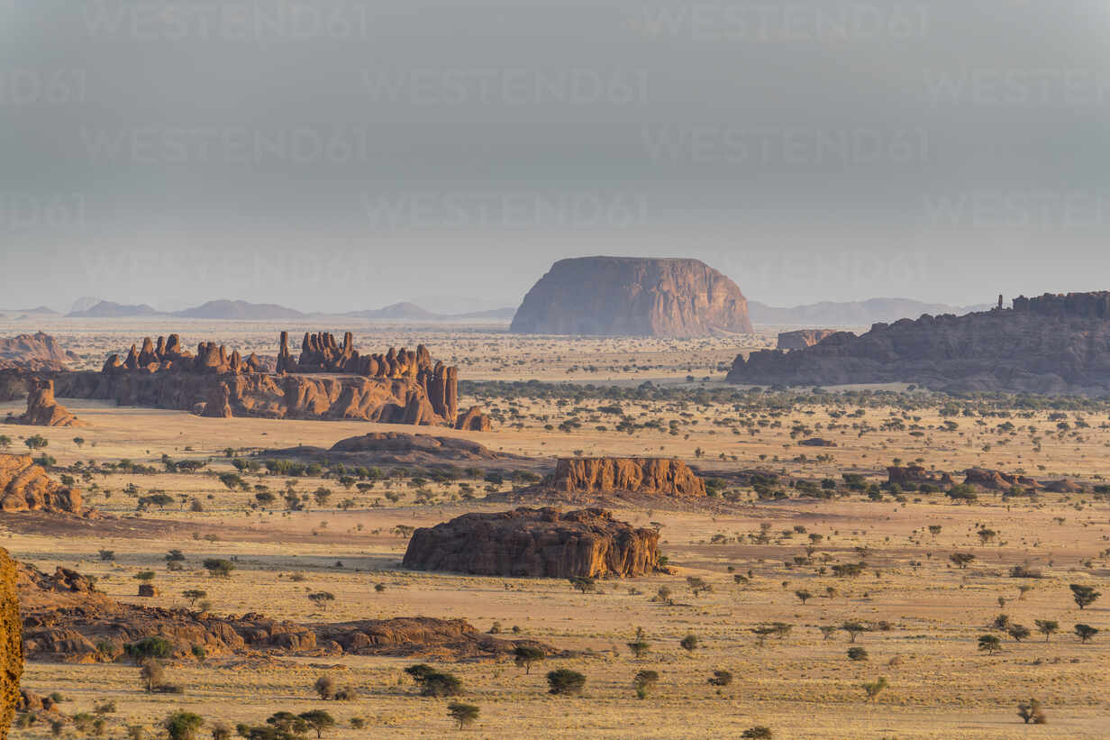A panoramic view of Chad's Ennedi Plateau, showcasing the vast desert landscape from a scenic hilltop perspective.