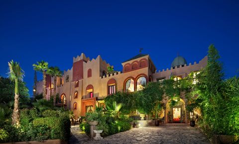 Night view of Kasbah Tamadot mansion, highlighting its elegant exterior and enchanting ambiance under the moonlight.