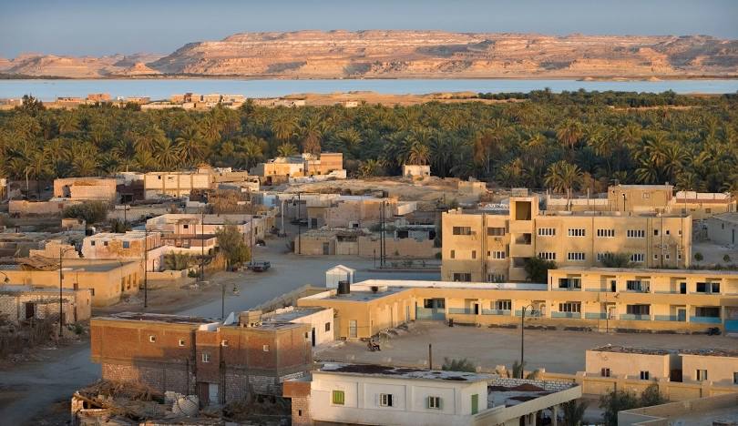 Desert city of Al-Kharj with distant mountains, Siwa Oasis, Egypt.