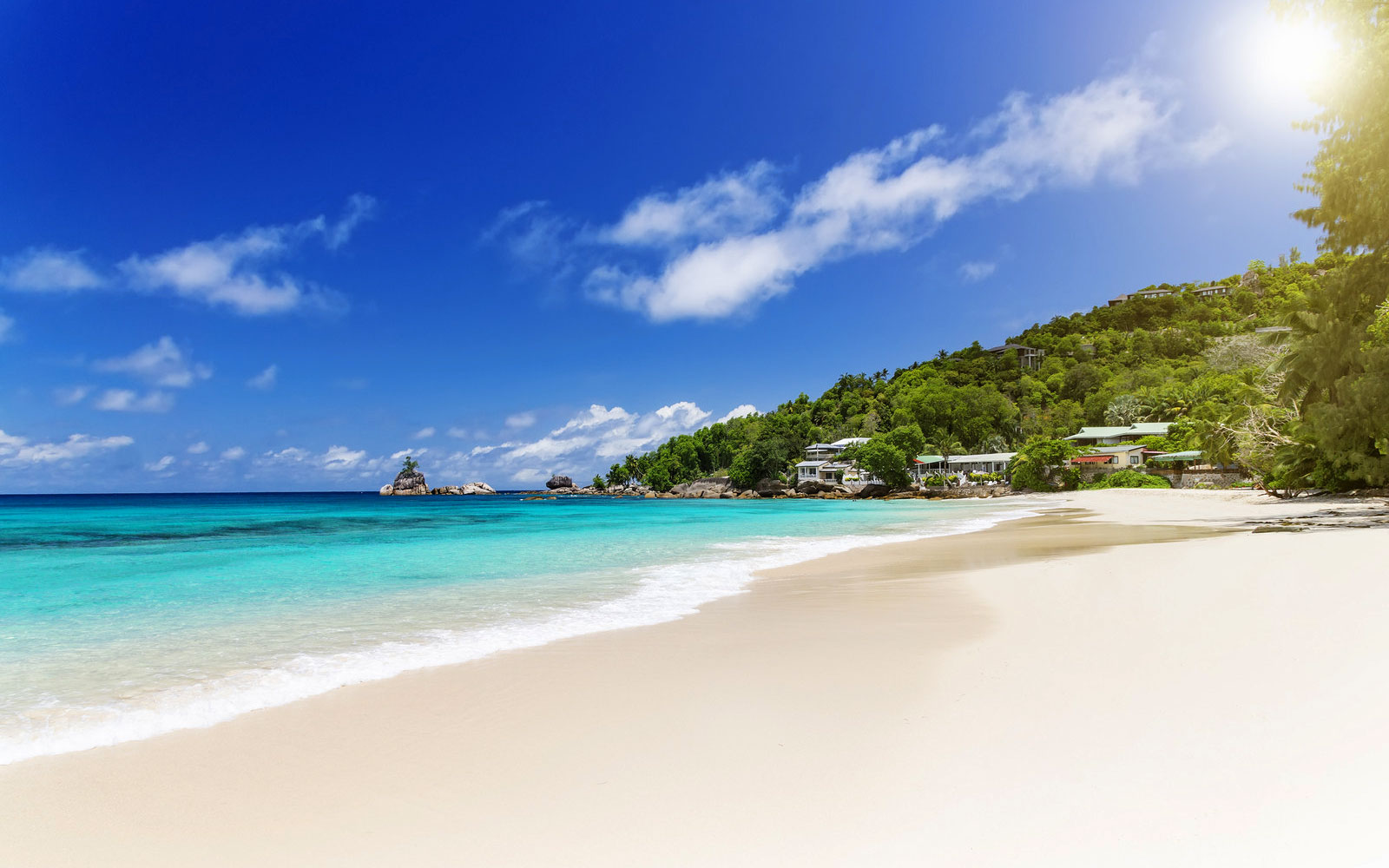 Anse Intendance beach in Seychelles showcases beautiful white sand and clear blue water, creating a picturesque coastal scene.