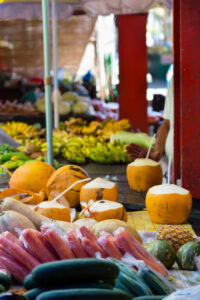 Drinking coconuts at fruit at the market in Victoria in Mahe, Seychelles