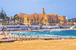 Monastir, Tunisia - May 06, 2007: View of Ribat, the Mediterranean Sea with waves and people who relax and play soccer