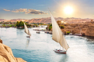 Thebes Traditional Nile sailboats near the banks of Aswan, Egypt.