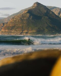 Surfer enjoying the sunset waves in Kommetjie outside of Cape Town in South Africa.