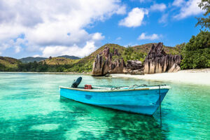 Old fishing boat on a Tropical beach at Curieuse island Seychelles. Horizontal shot