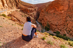 Young woman enjoying scenic view at Dades Valley - Morocco