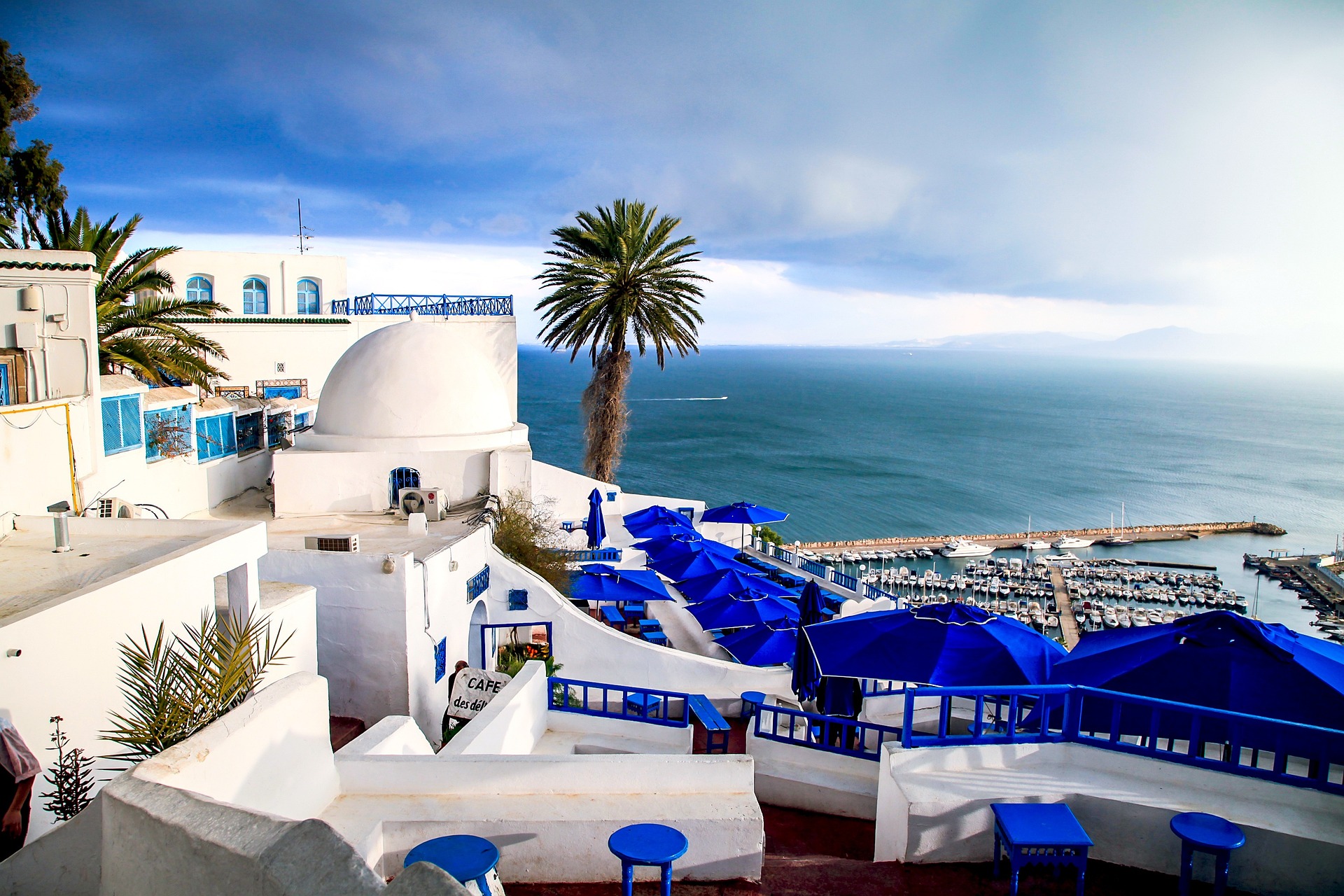 A clear blue sky adorned with fluffy white clouds, creating a serene and tranquil atmosphere.